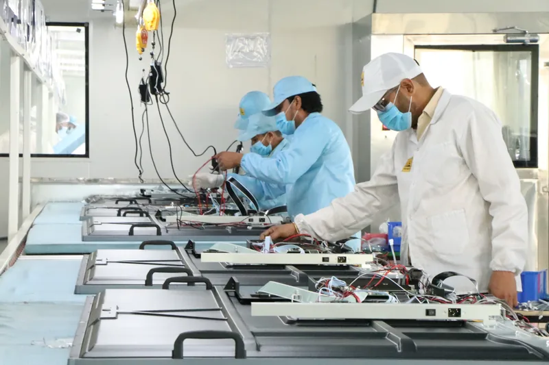 SNL technicians assembling PCB display panels on the in-house CKD integration line